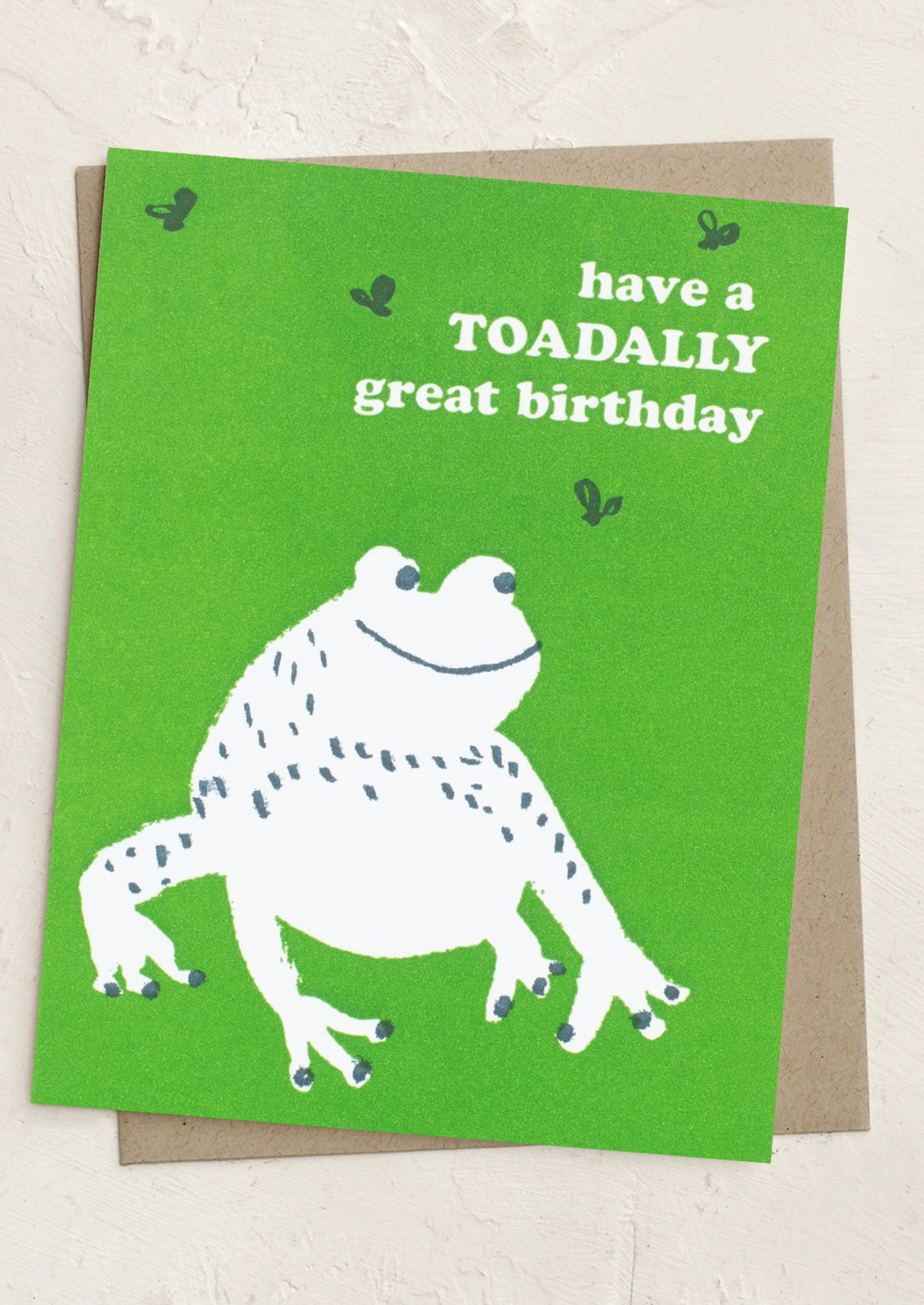 Birthday card with a frog illustration and text on a green background