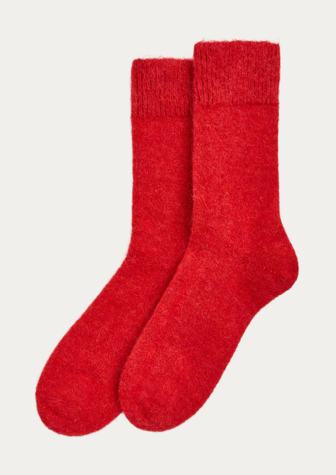 A pair of textured alpaca blend, calf-length socks in bright red.