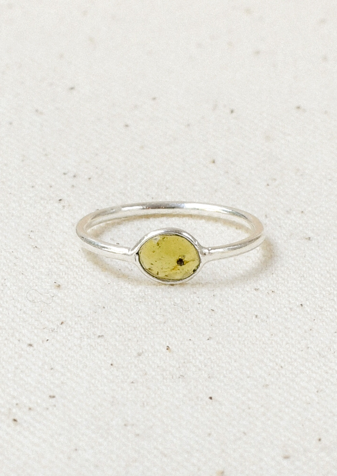 A sterling silver ring with a green tourmaline  stone set in the center.