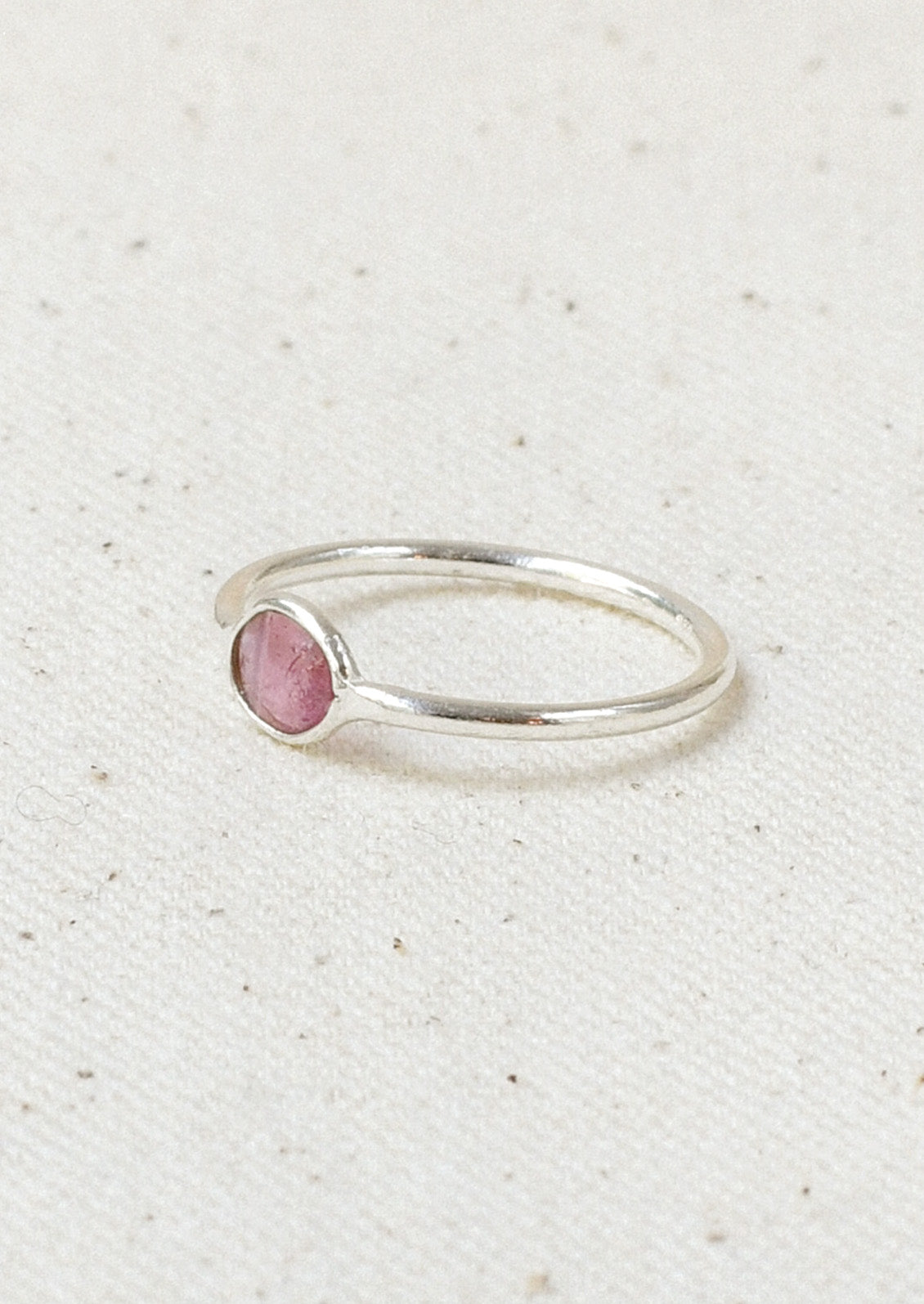 A sterling silver ring with a pink tourmaline  stone set in the center.