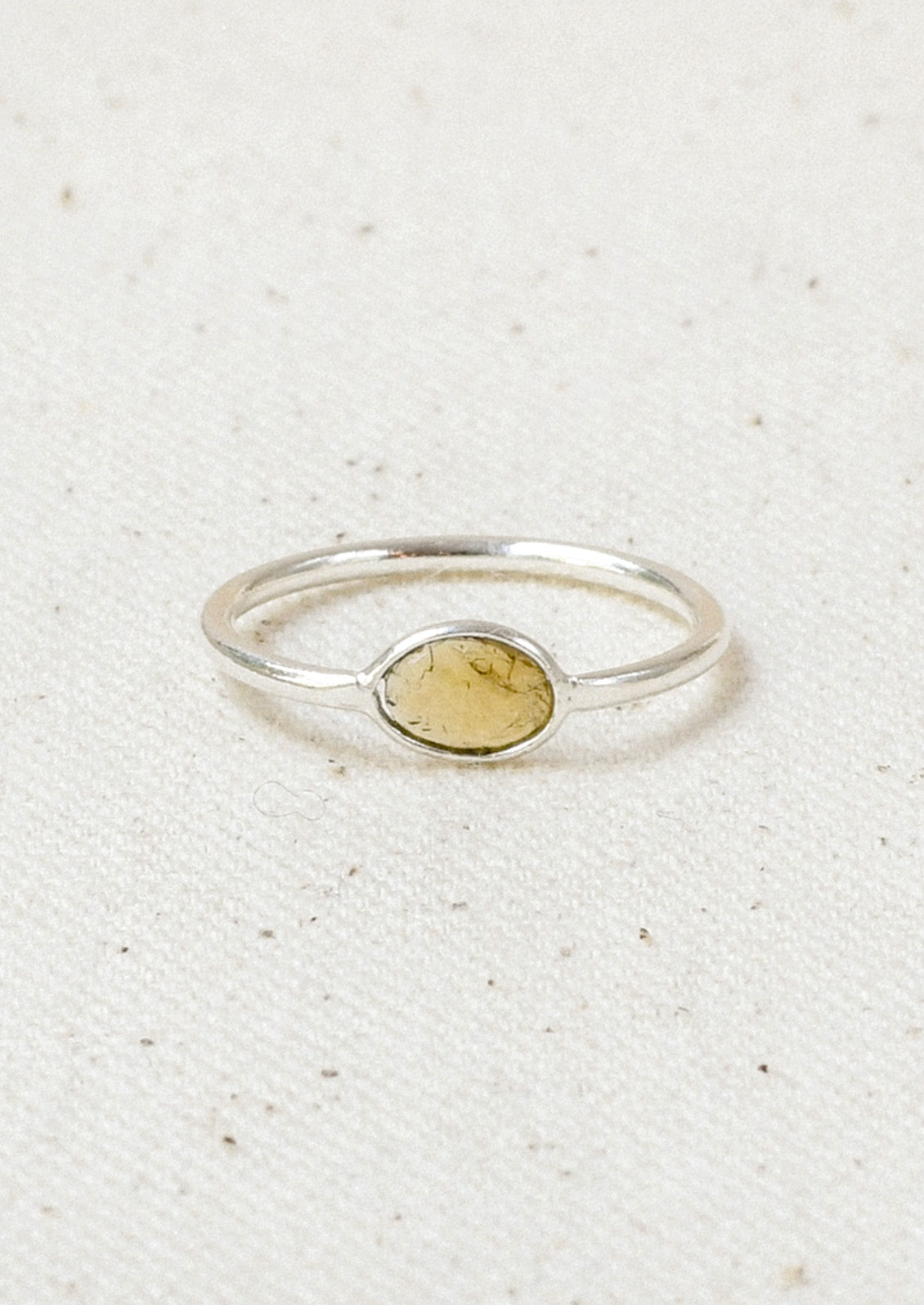 A sterling silver ring with a yellow tourmaline  stone set in the center.
