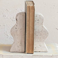 1: A pair of natural travertine bookends with wavy squiggle shape.