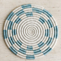2: A woven sweetgrass trivet with geometric pattern in white and sky blue.