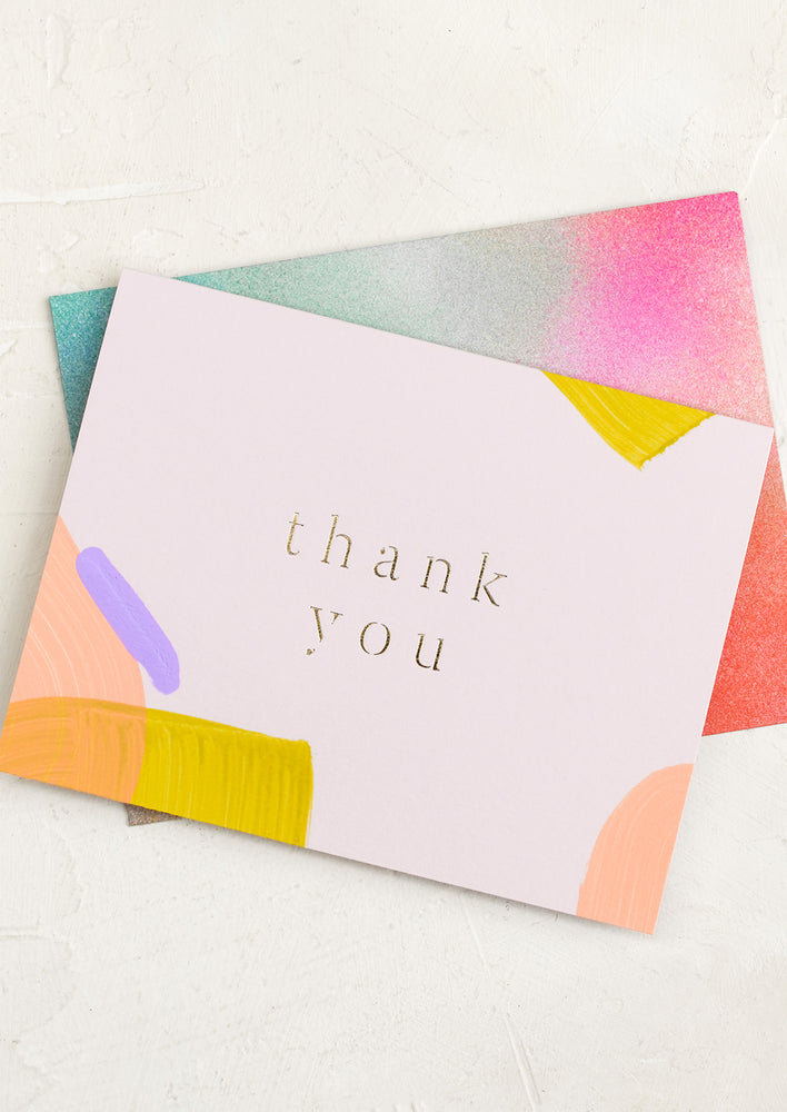 1: A painted multicolor thank you card.