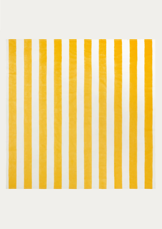 A tablecloth with wide yellow and white stripe pattern.
