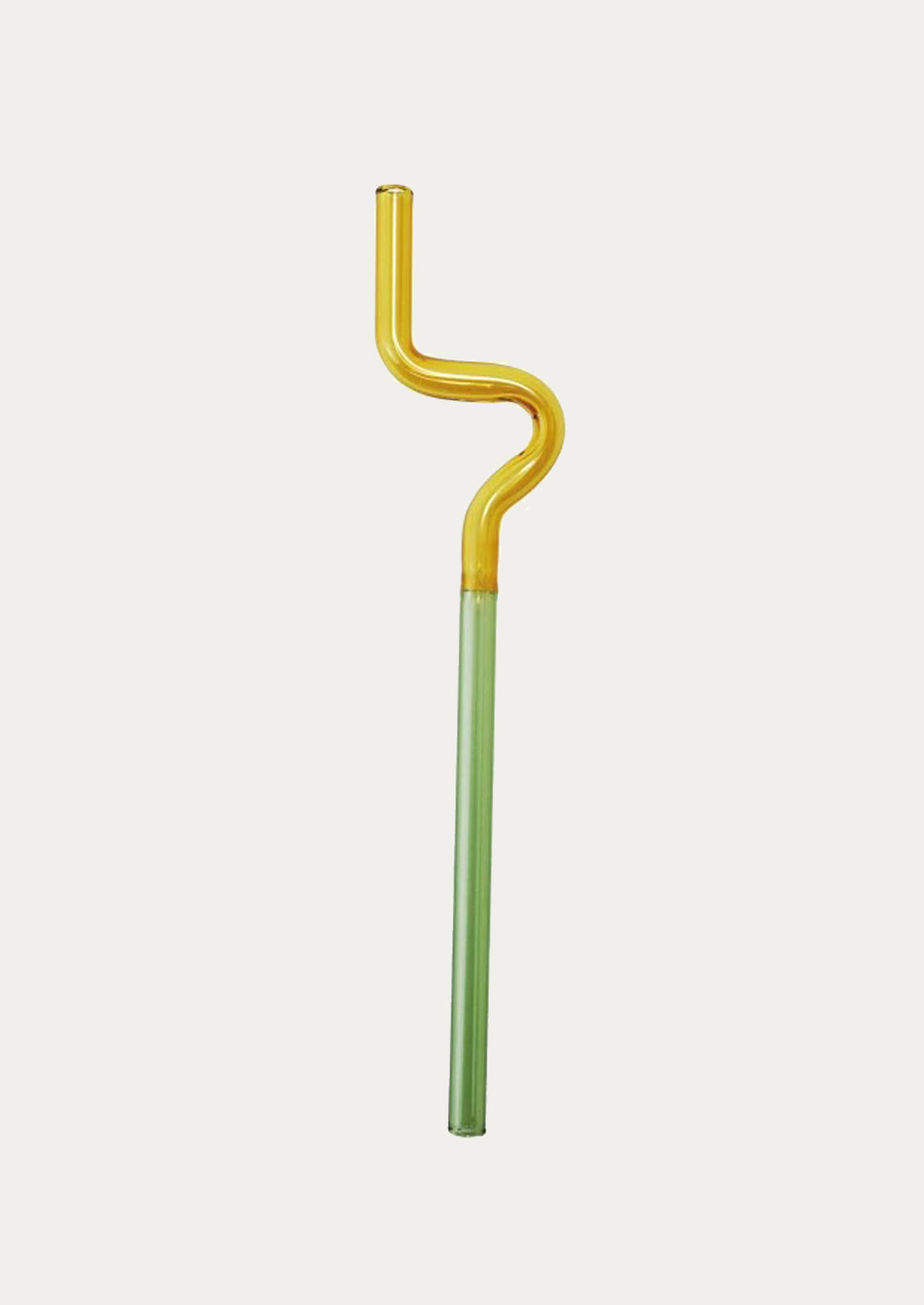 Bent glass straw with yellow top and green bottom on a light gray background