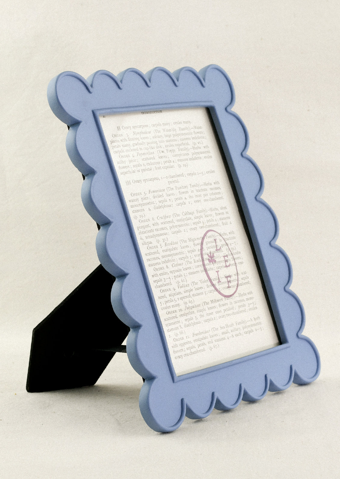 A powder blue 5" x 7" picture frame with a scalloped design.