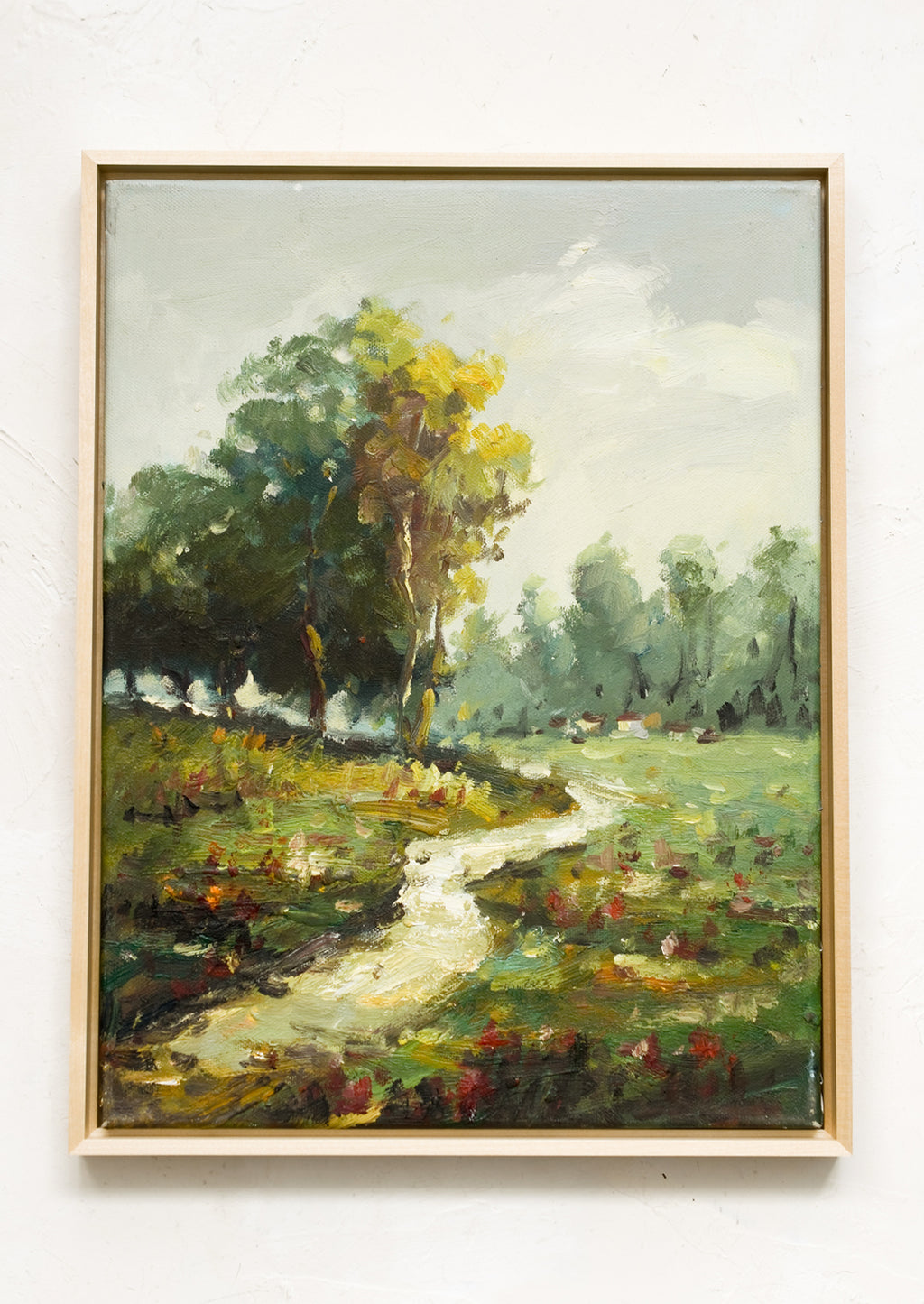 1: A framed landscape oil painting of a path running through a flowery meadow.