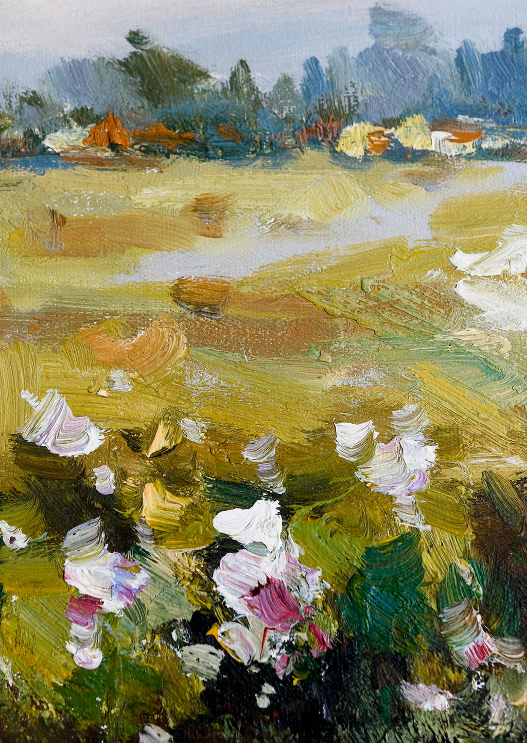 2: A framed original oil painting of a colorful meadow in the countryside.
