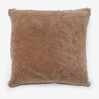 Fawn: A velvet throw pillow with pom pom trim in fawn color.