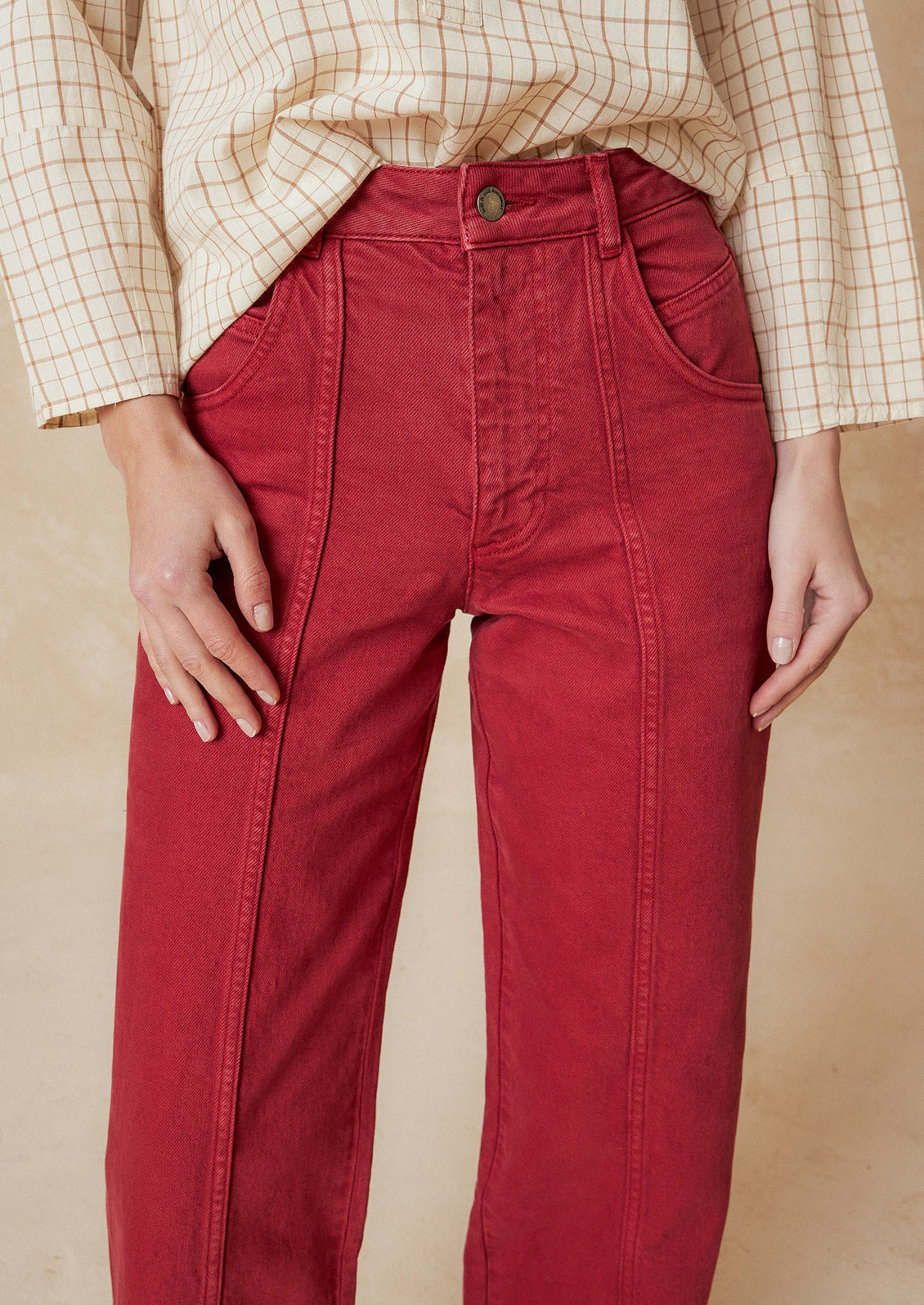 A pair of red wide leg jeans with vertical seam down front.