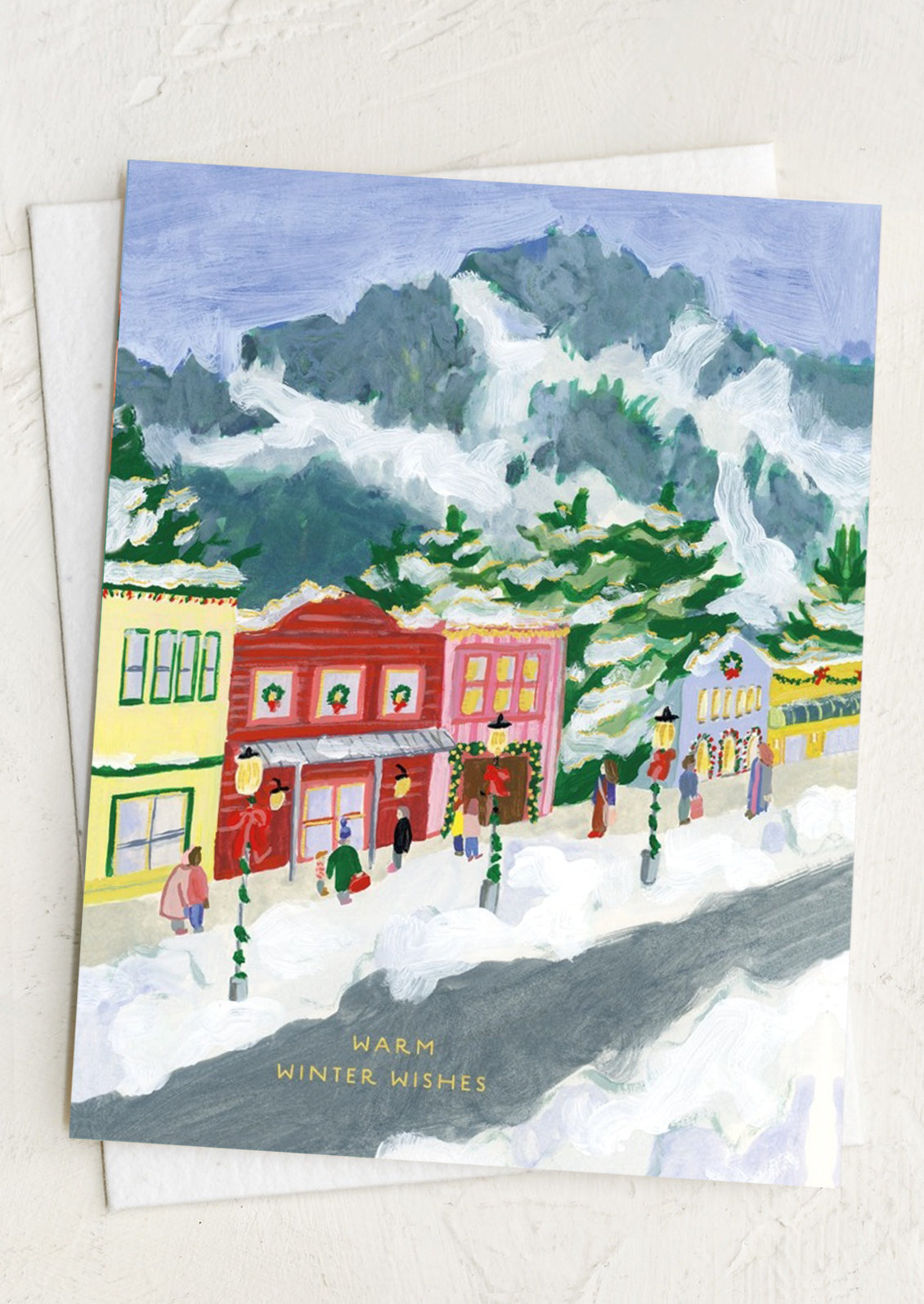 Winter scene with colorful buildings and people on a snowy street, with 'Warm Winter Wishes' text.