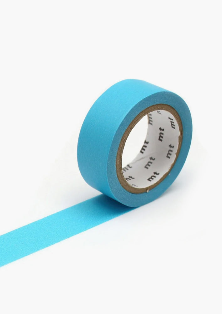 A roll of washi tape in solid turquoise color.