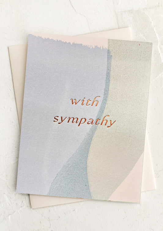 Greeting card with 'with sympathy' text on a watercolor background.
