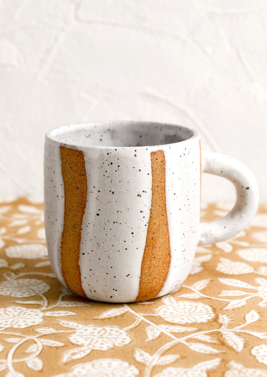 White Speckle: A ceramic mug with wavy stripe pattern in white.
