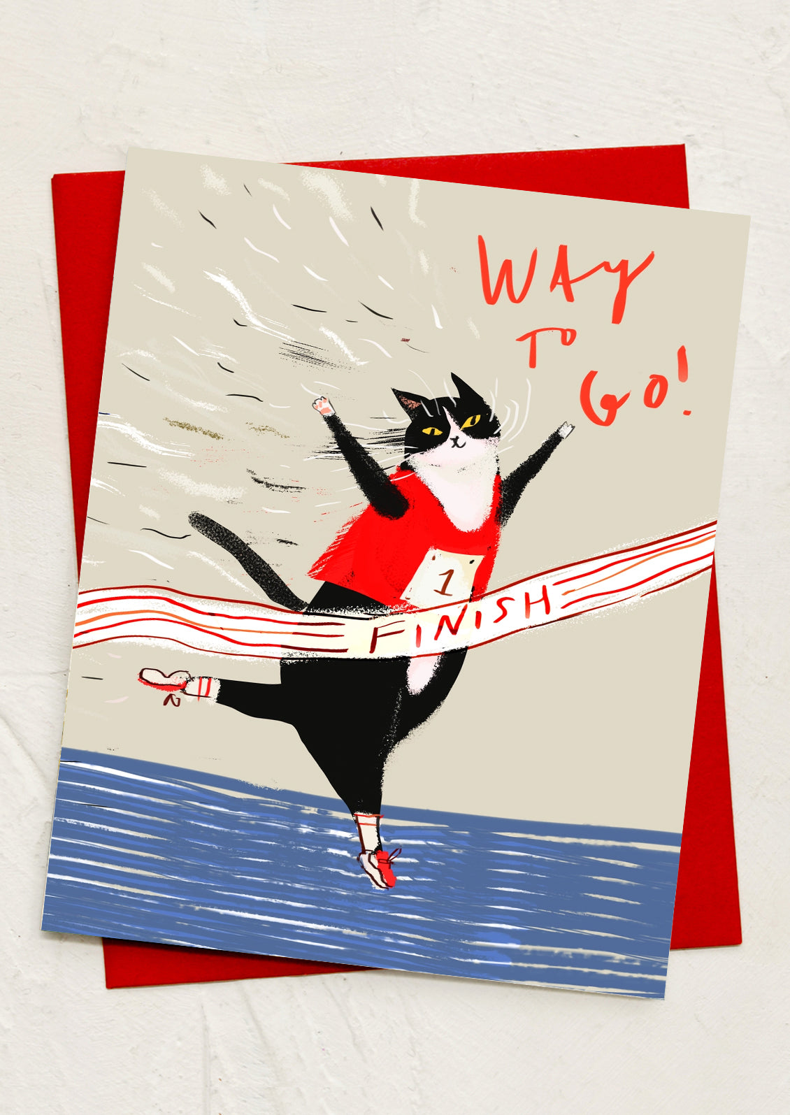 A greeting card with illustration of a cat at finish line, text reads "Way to go!".