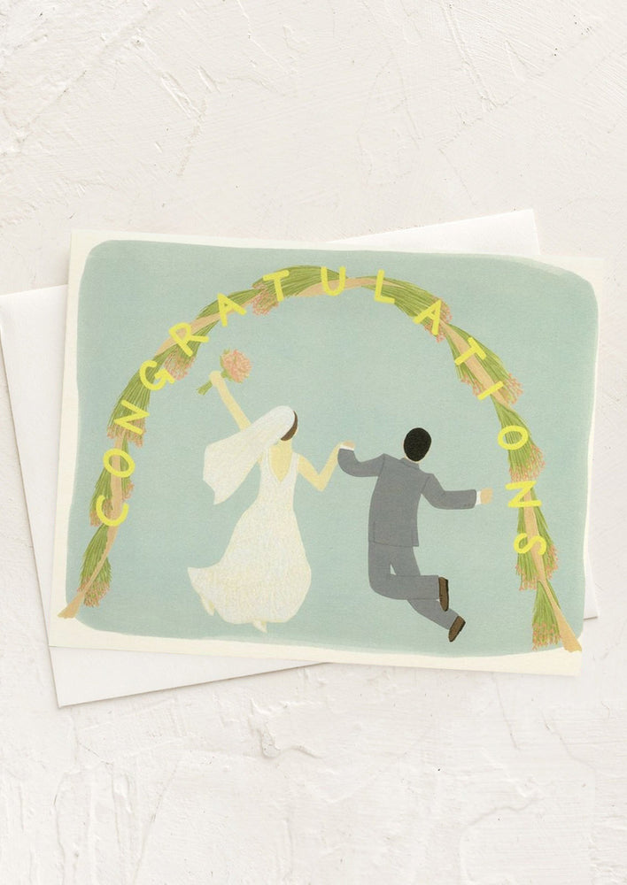 An illustrated card with bride and groom leaping under an arch.