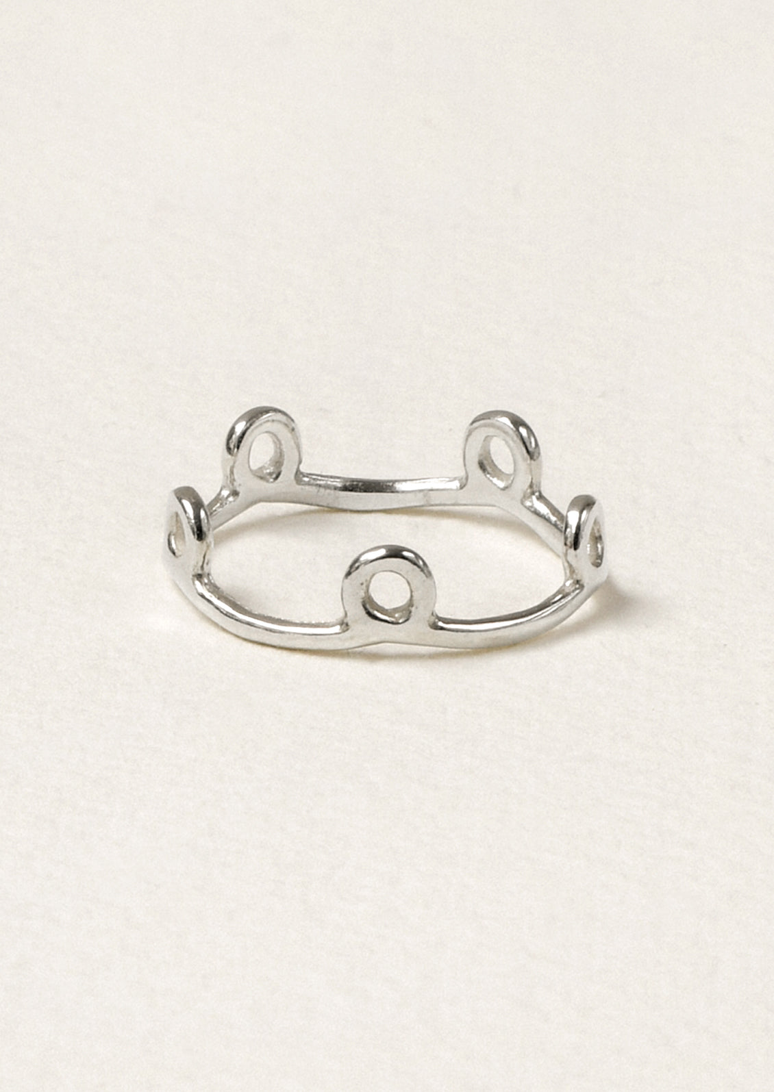A sterling silver ring with small circles along the band.