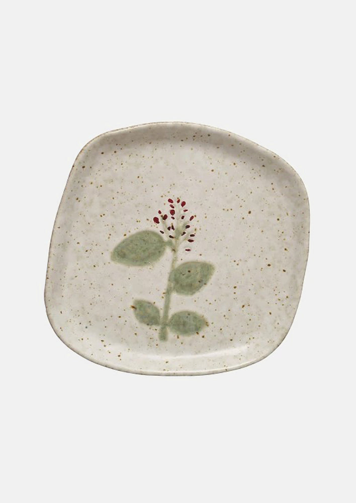 Ceramic plates in asymmetrical shapes with wildflower patterns.