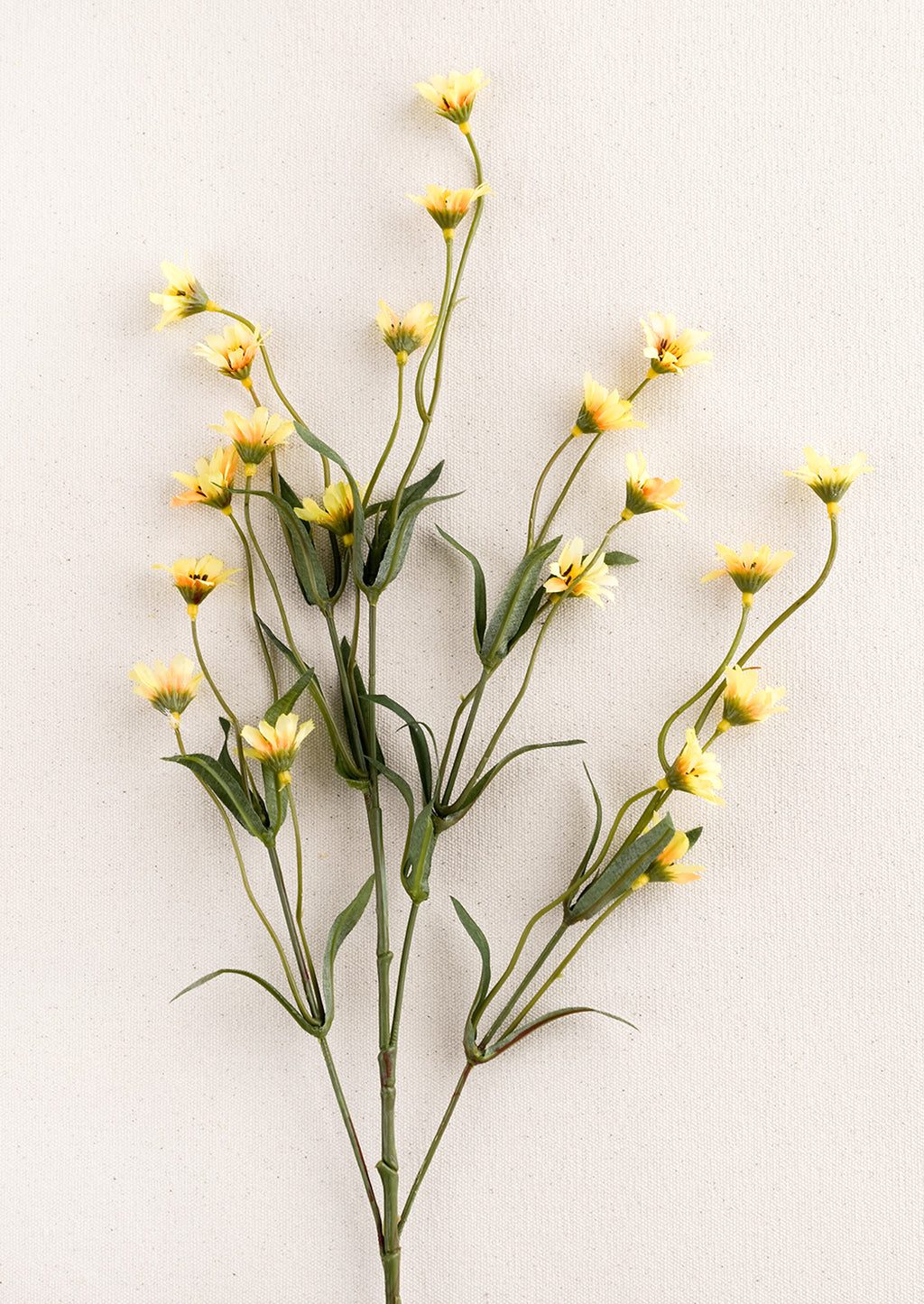 2: A faux flora spray of yellow wild daisy.