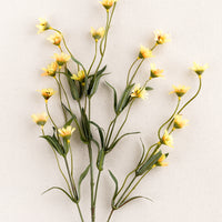 2: A faux flora spray of yellow wild daisy.