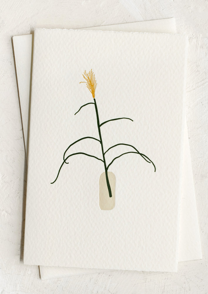 A blank card with letterpressed image of a stalk of pampas grass.