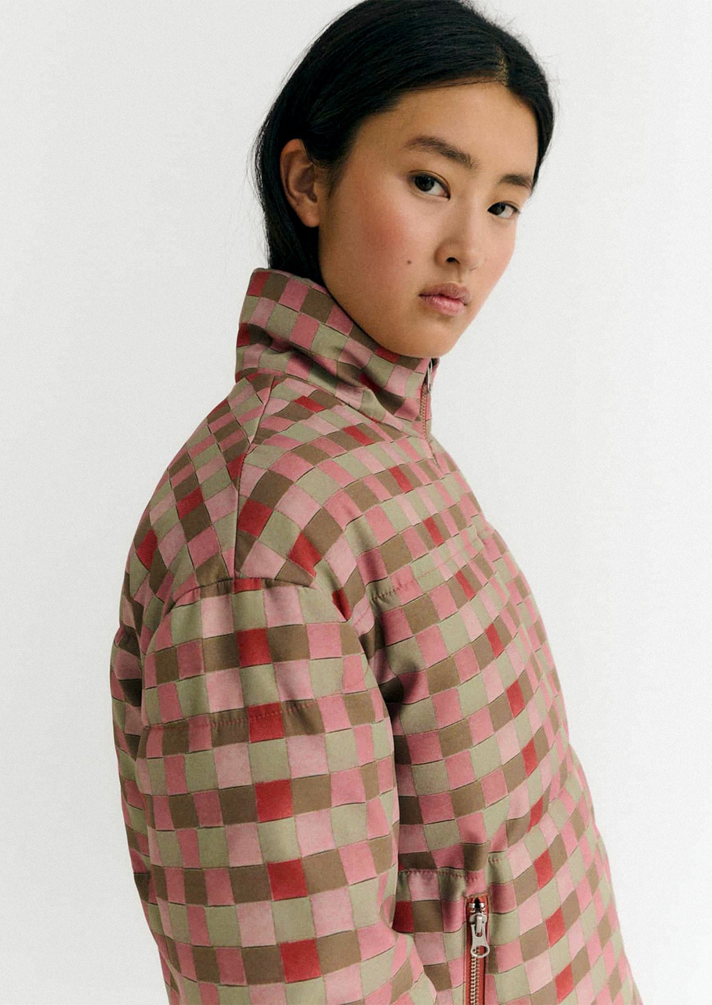 Person wearing a checkered jacket on a white background