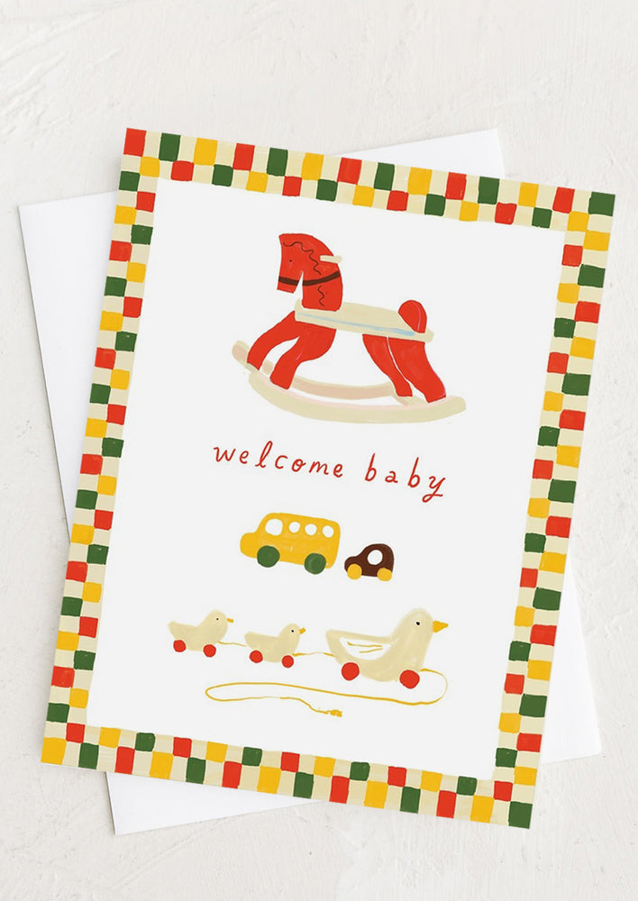 1: A greeting card with illustration of wooden baby toys.