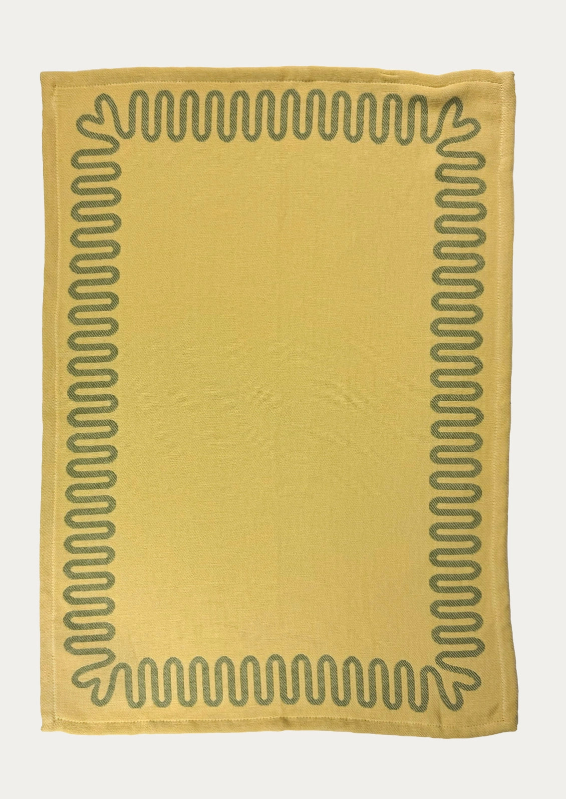 A yellow dish towel with green squiggle border.