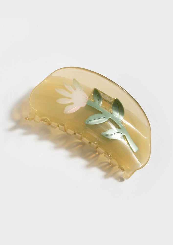 Yellow / Thistle: A transparent yellow curved shape hair claw with thistle design.