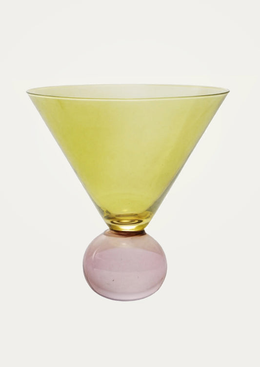 Glass with yellow top and pink base on a white background