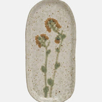 Tall Yellow Flower: Ceramic plates in asymmetrical shapes with wildflower patterns.