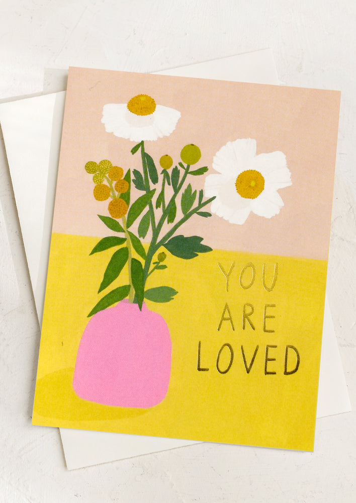 A card with illustration of flowers in vase, text reads "You are loved".