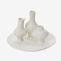 2: A sculptural multi vessel plate with bud vases in white ceramic.