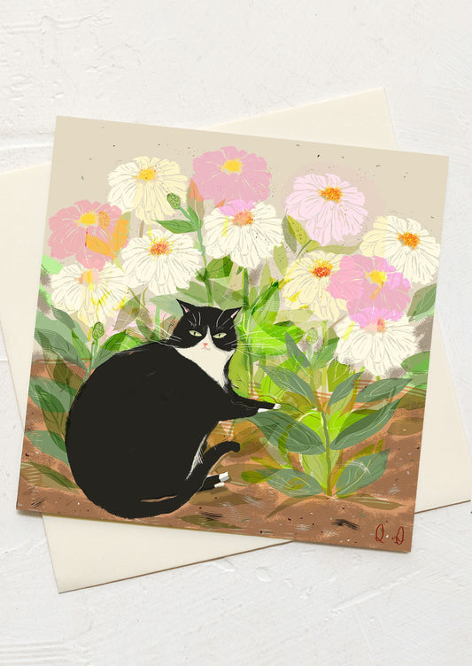 A greeting card with illustration of a cat sitting in a garden of zinnias.