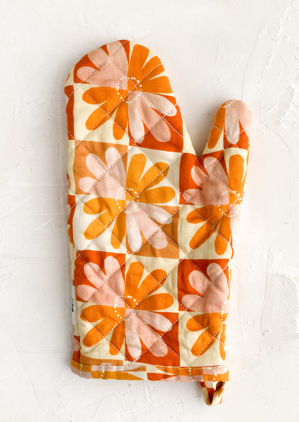 Tomato Multi: A retro floral print quilted oven mitt in red, yellow, orange and pink.
