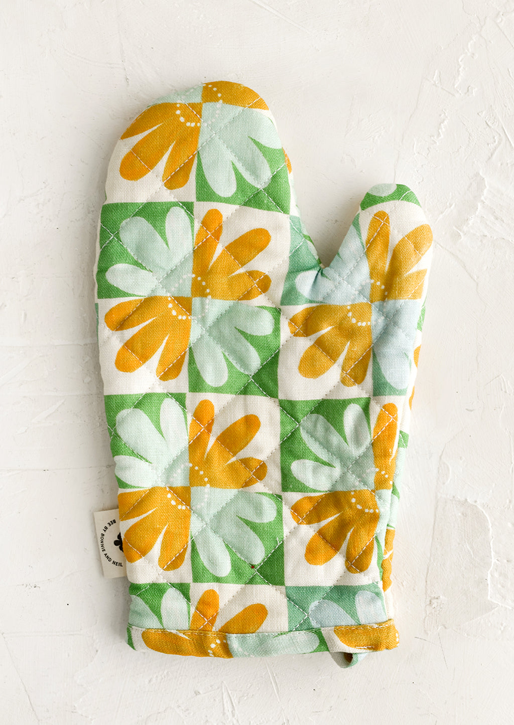Herb Multi: A retro floral print quilted oven mitt in mint, yellow and green.