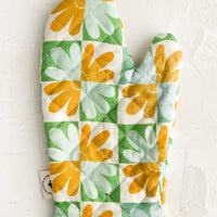 Herb Multi: A retro floral print quilted oven mitt in mint, yellow and green.