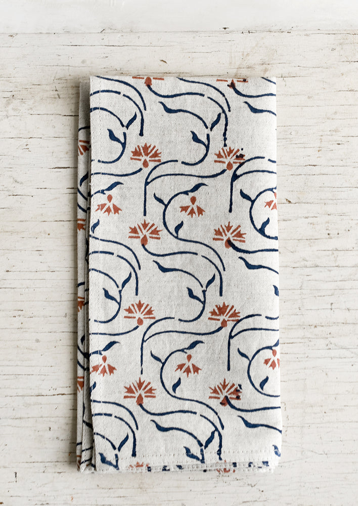 1: A block printed linen napkin with floral line print.