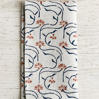1: A block printed linen napkin with floral line print.