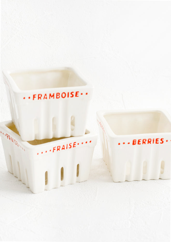 Ceramic berry baskets made to look like the disposable variety, but in white ceramic with red letters in French.