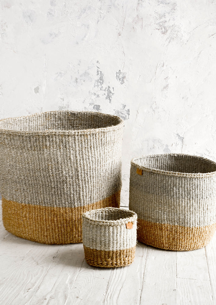 2: Three storage baskets woven from sisal in grey & natural two tone design. Shown in three incremental sizes.
