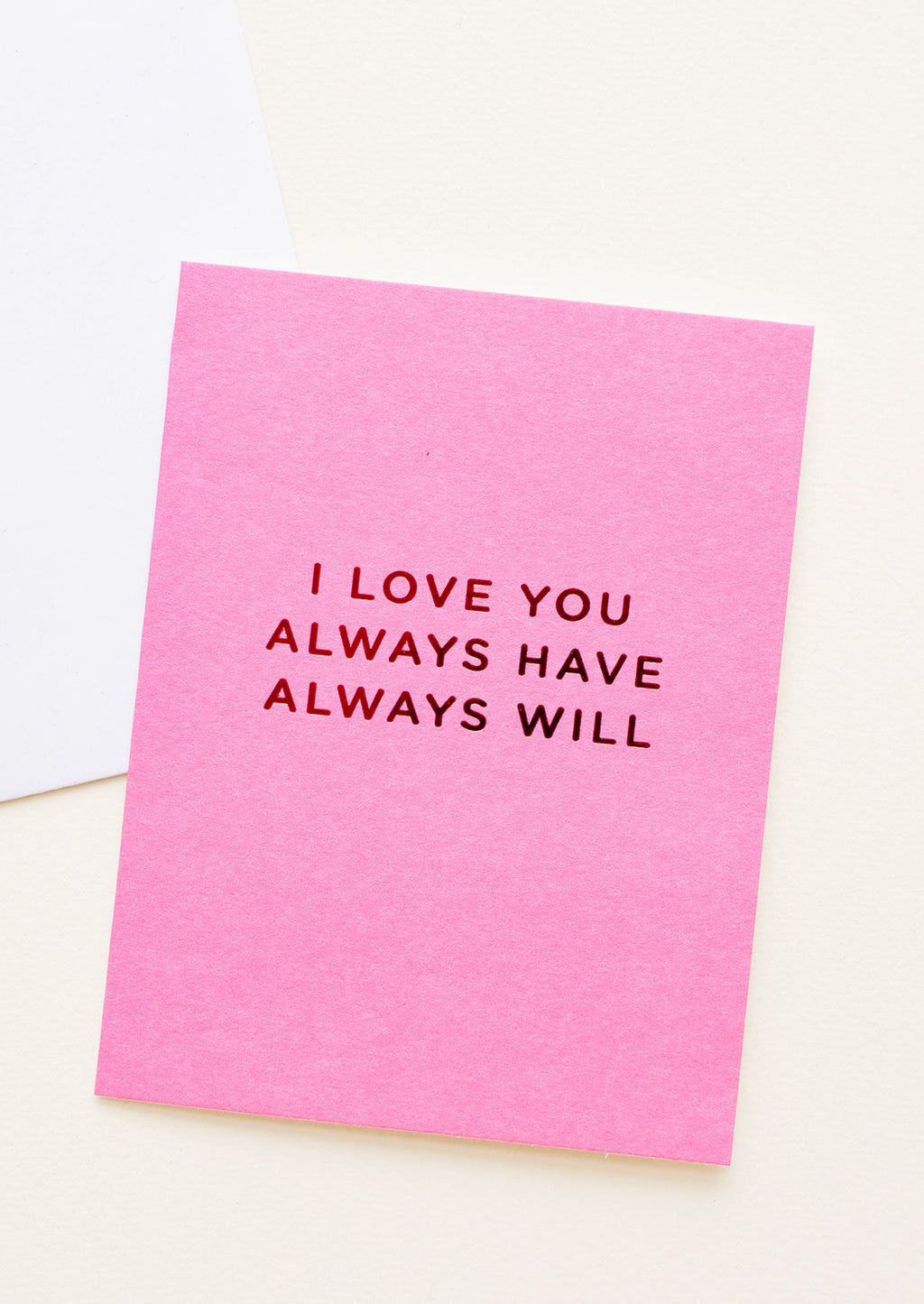 1: A bright pink greeting card with "I love you always have always will" in red foil.