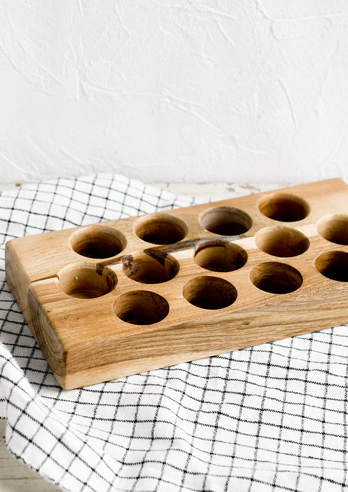 A wooden egg holder tray.