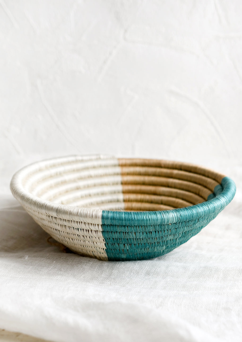 2: A round sweetgrass bowl in navy pattern.