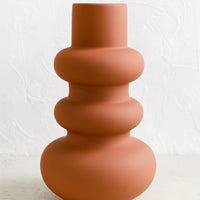 Large / Rust: A large matte vase with curvy shape in terracotta color.