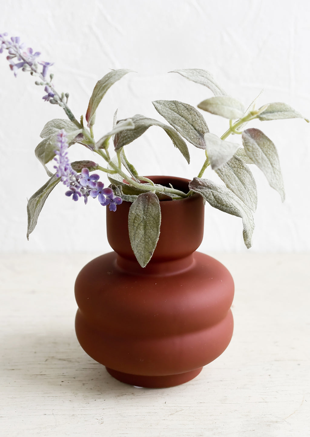 Small / Crimson: A small matte-finish dark red vase with purple flower.