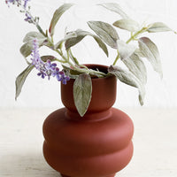 Small / Crimson: A small matte-finish dark red vase with purple flower.