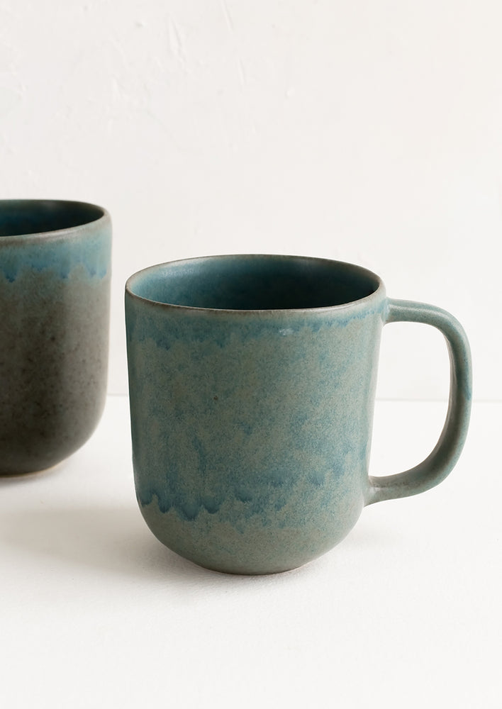 2: A ceramic mug in mottled matte sea blue glaze.