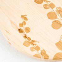 2: Botanical lasercut etched pattern on a maple wood cutting board.